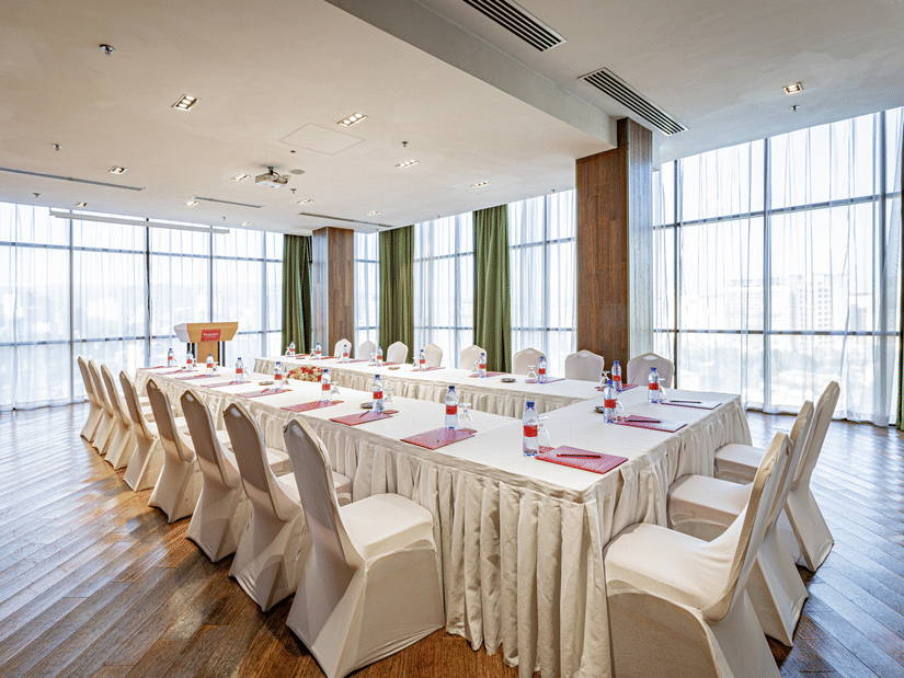 An overview of a meeting room with a U-shaped table and chairs in view - Ramada by Wyndham Addis, Addis Ababa.
