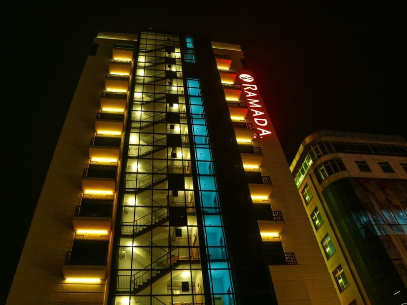 The exterior facade of Ramada by Wyndham Addis, Addis Ababa during the night with the lights on.