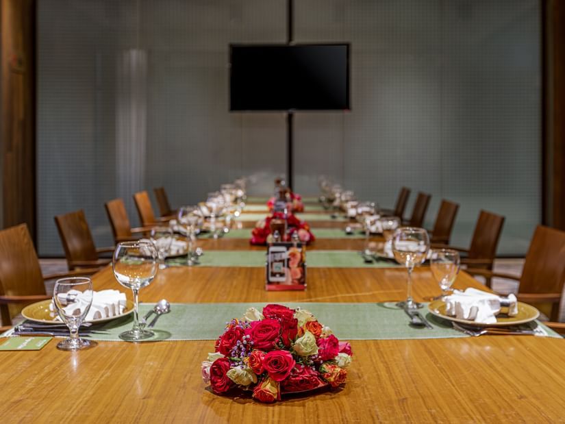 A close up shot of the dining table with many chairs and items kept on it inside FOGO NO CHÃO - Ramada by Wyndham Addis, Addis Ababa