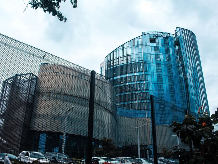 An overview of a glass exterior building with blue sky in the background.