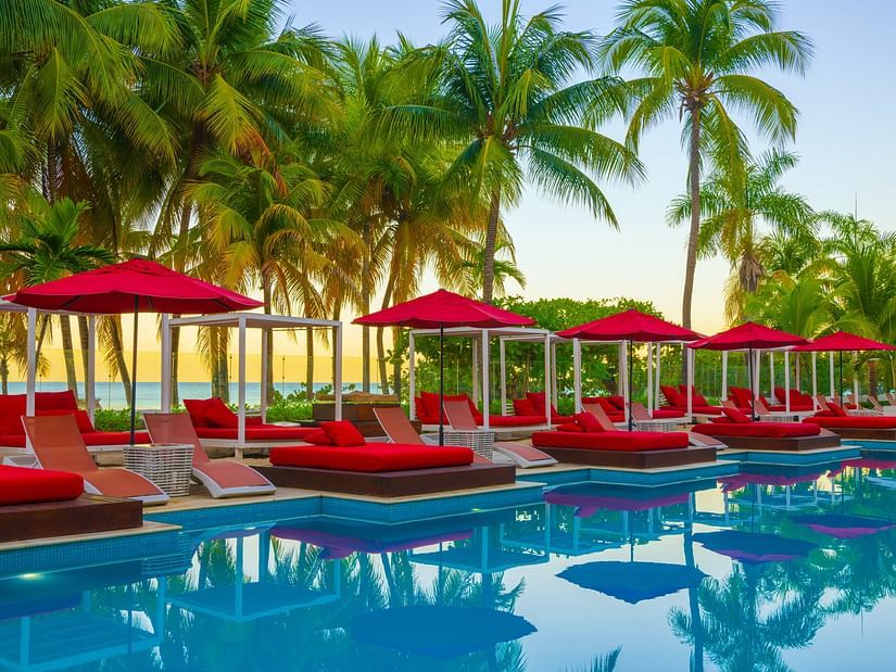 swimming pool with red sun loungers on the deck at S Hotel Montego Bay, Jamaica