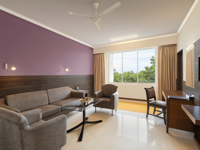 An overview of the living room in the Suite at Sangam Hotel, Thanjavur - Thanjavur Hotel Location