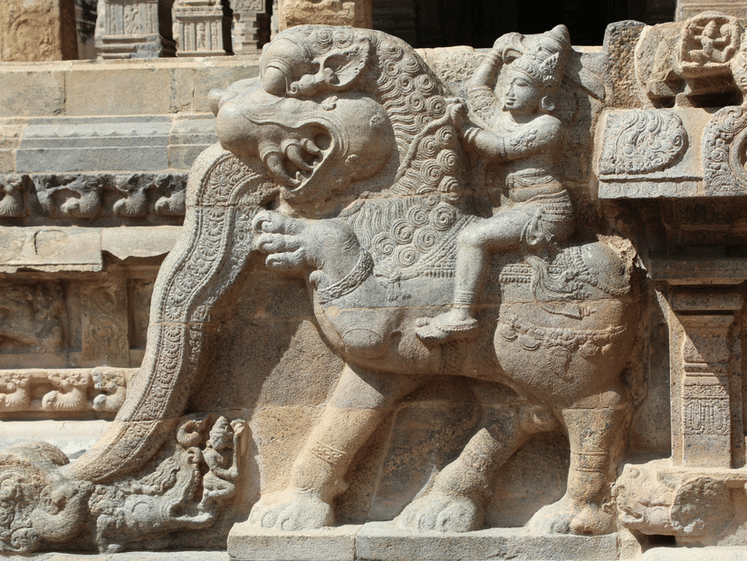 Intricately carved stone sculpture of a mythical lion-like creature adorning an ancient temple, showcasing remarkable craftsmanship and architectural heritage details