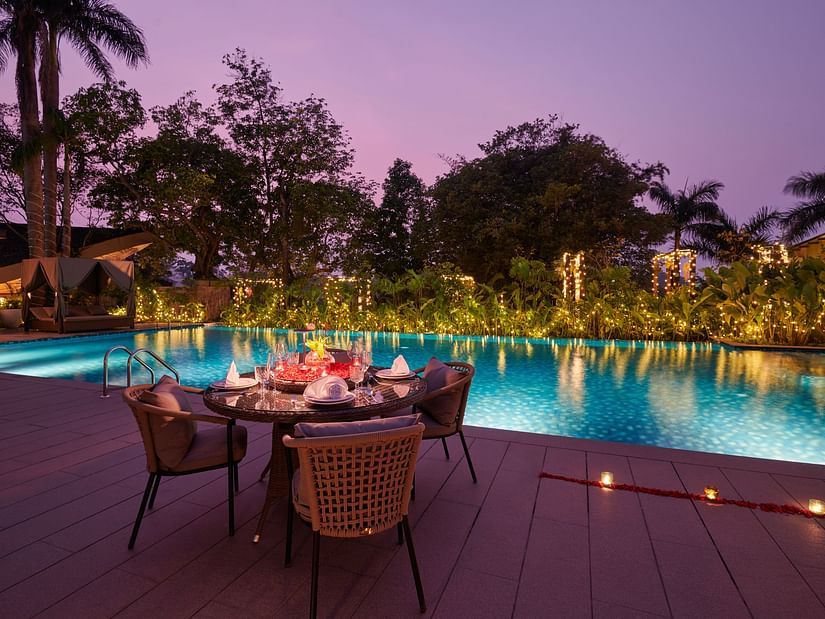 Special dining setup by the swimming pool with candles at The Dukes Retreat