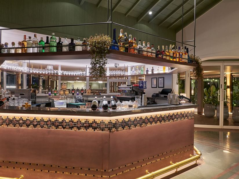 Well-stocked bar with a variety of bottles neatly arranged on shelves at The Dukes Retreat
