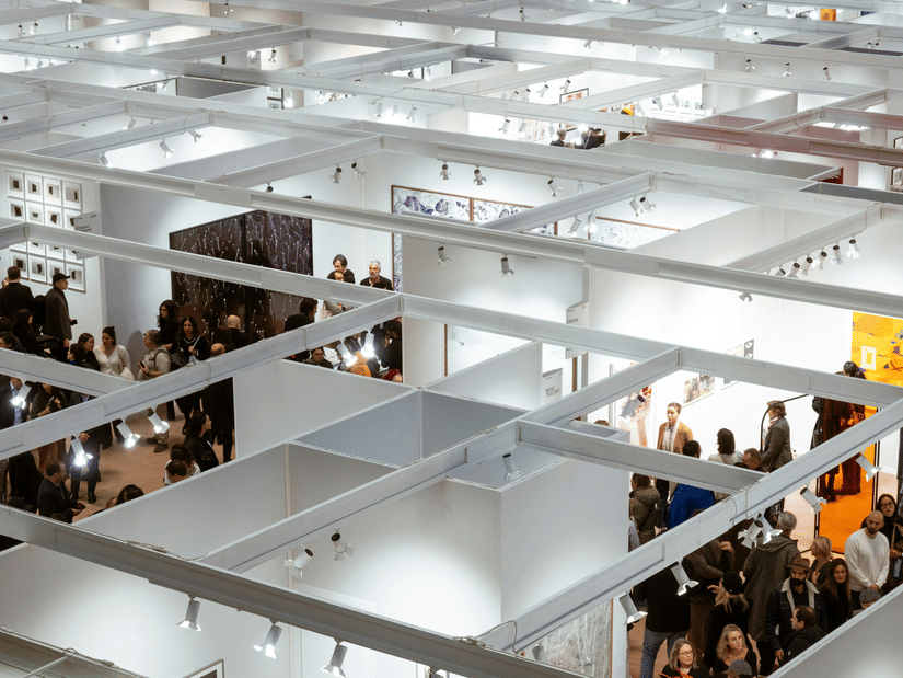An aerial view of a trade show with people walking around near the numerous stalls.