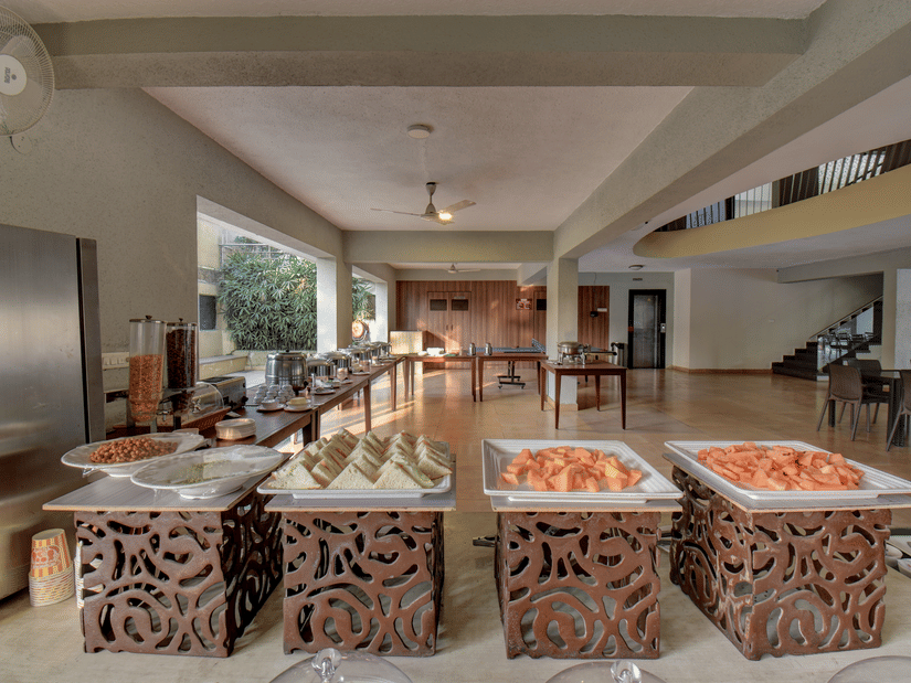 Buffet setup with a variety of dishes placed on a table in the restaurant at VITS Lonavala.