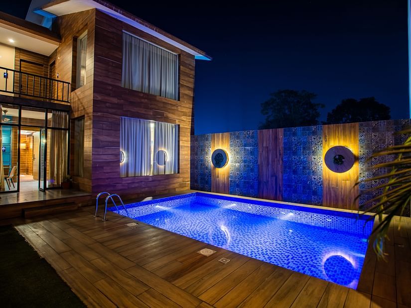 facade image of a building with a swimming pool in front in the night - Wedlock Greens Hotel Resorts Dhanbad