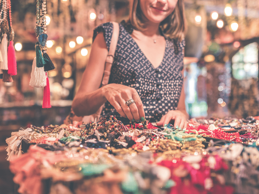 A woman looking at the various items on display to shop