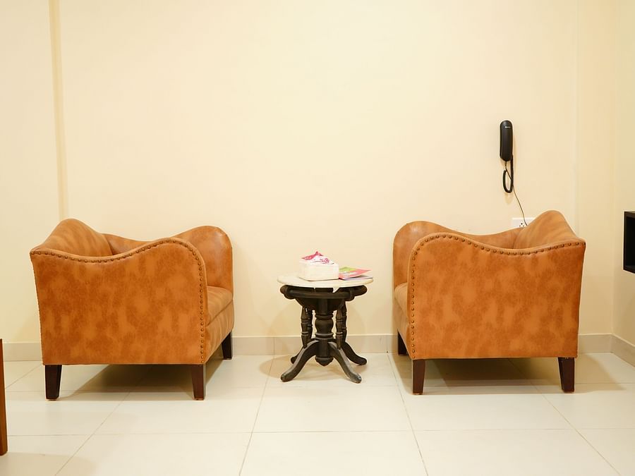 an image featuring two sofa chairs and a table - A M Suites