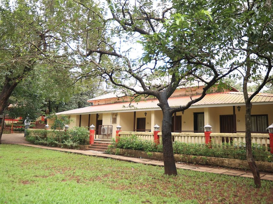 Image featuring a wide building Exterior with trees around -  Adamo the Village