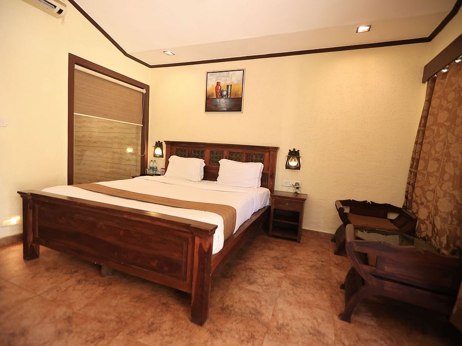 Image of room interior with a bed, sofa and brightly lit - Adamo the Village accommodation