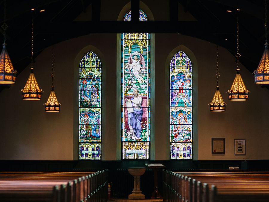 a view of a church with chandeliers hanging from the ceiling.