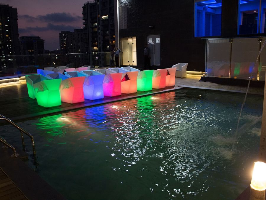 The Empresa Boutique Hotel - the rooftop area with colourful seats beside the swimming pool