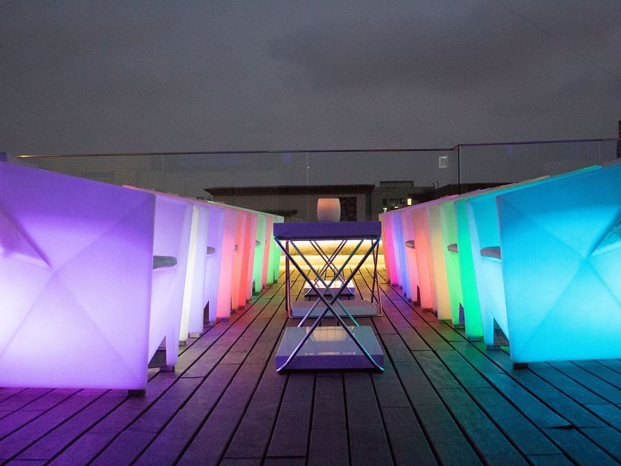 The Empresa Boutique Hotel - the rooftop area with colourful seats during nighttime