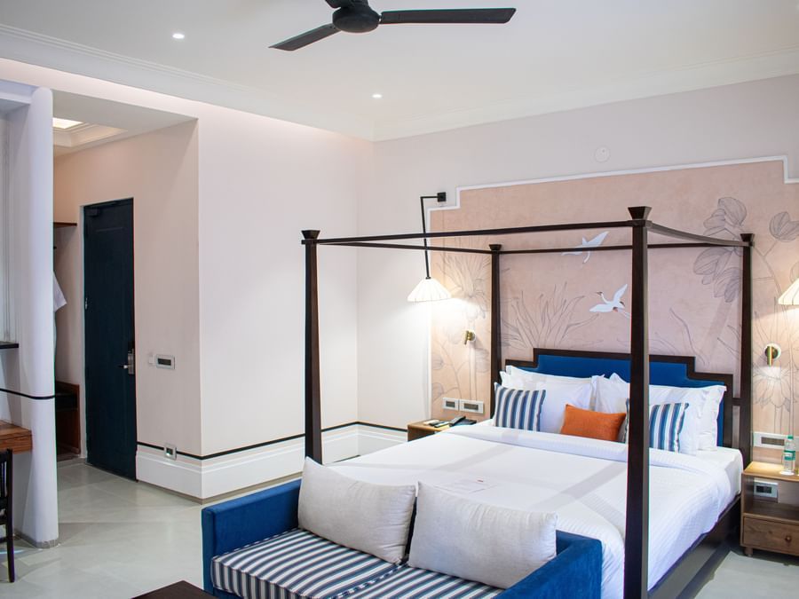 View of a cosy poster bed at The Sierra featuring a sofa