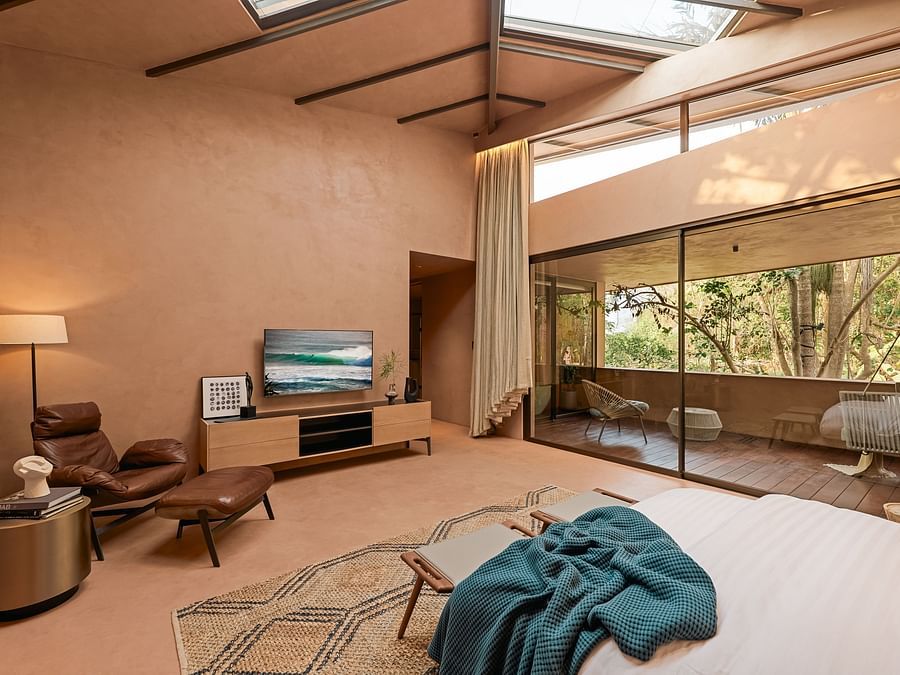 Stylish lounge with skylight roof and tranquil garden view at Villa Moira.