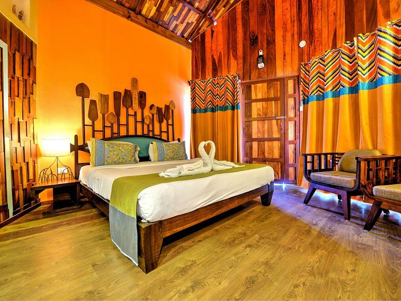 room with a king size bed and quirky yellow interiors
