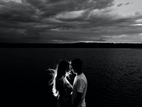 couple standing next to ocean