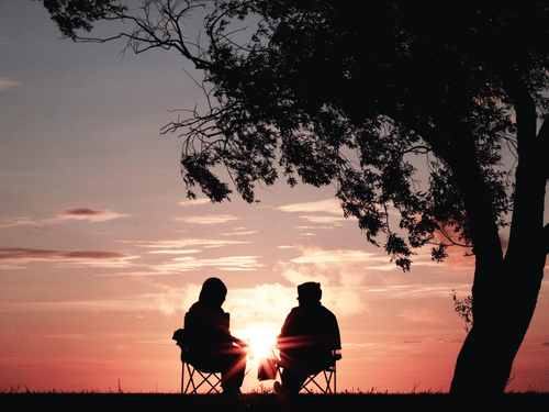 couple sitting under tree