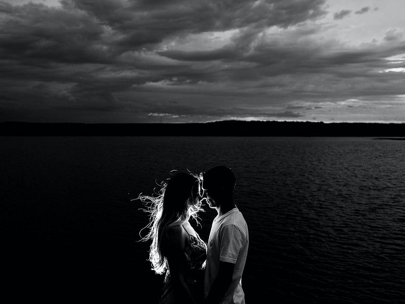 couple standing next to ocean