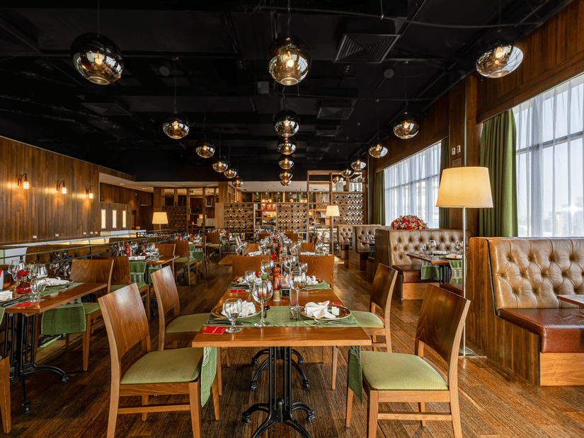 An overview of the many tables and chairs inside FOGO NO CHÃO restaurant - Ramada by Wyndham Addis, Addis Ababa