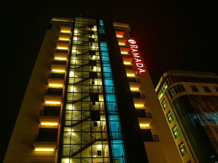 The exterior facade of Ramada by Wyndham Addis, Addis Ababa during the night with the lights on.