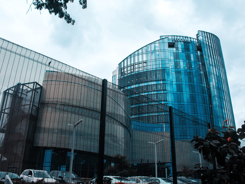 An overview of a glass exterior building with blue sky in the background.
