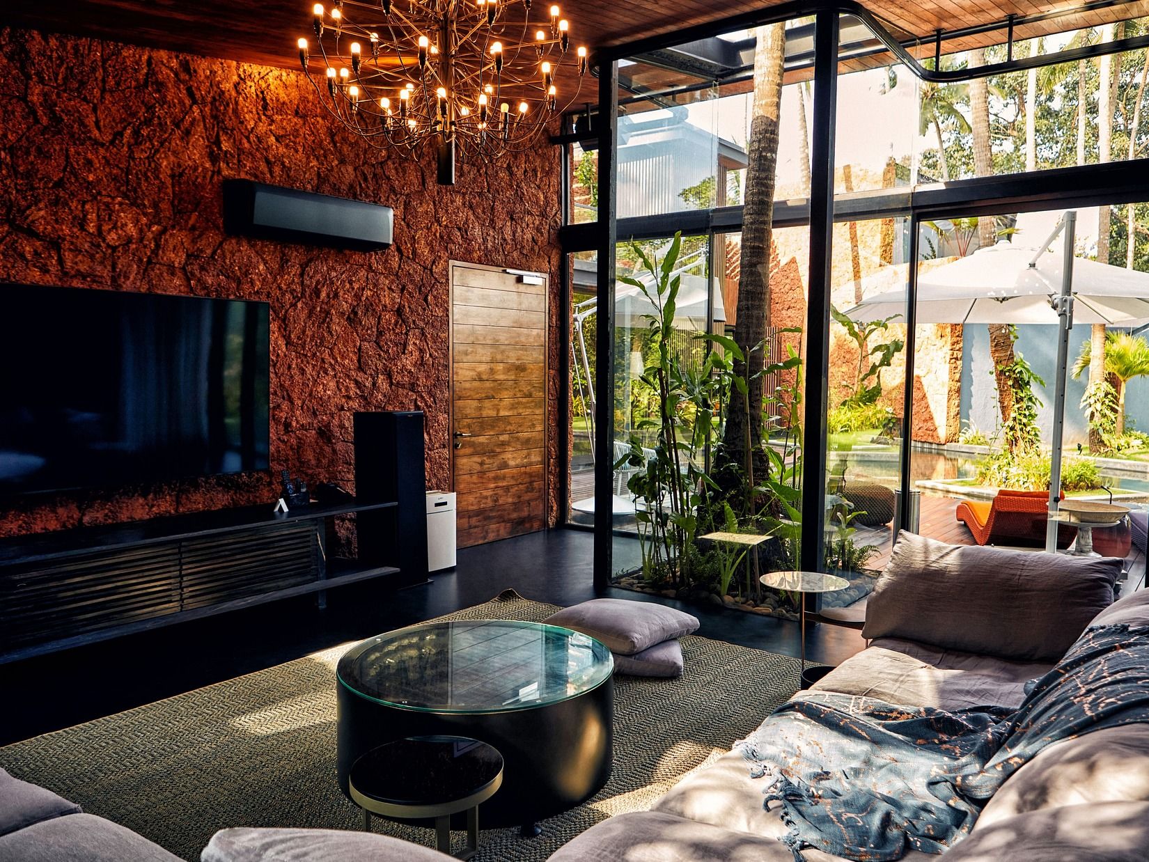 A luxurious living room with a sofa in front of a television at Villa In Palms by V Escapes