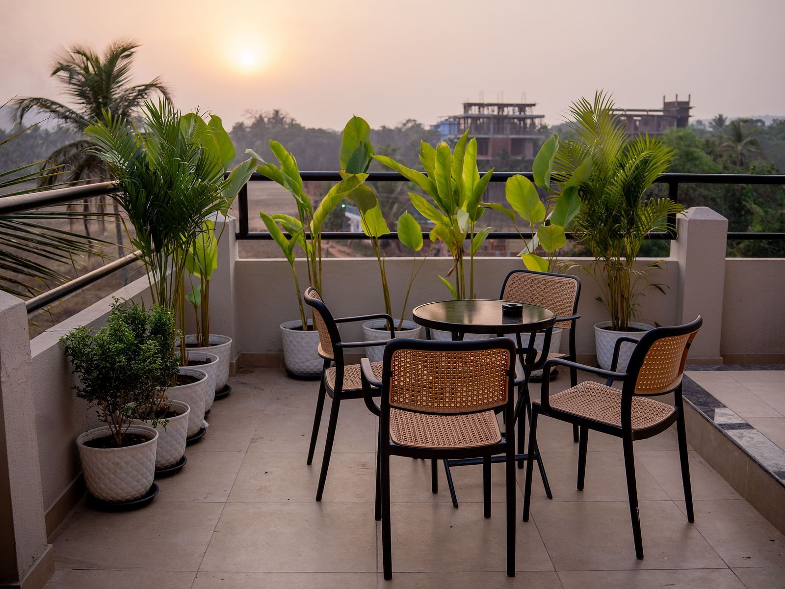 Balcony dining setup surrounded by potted plants and scenic views at Kssemya.