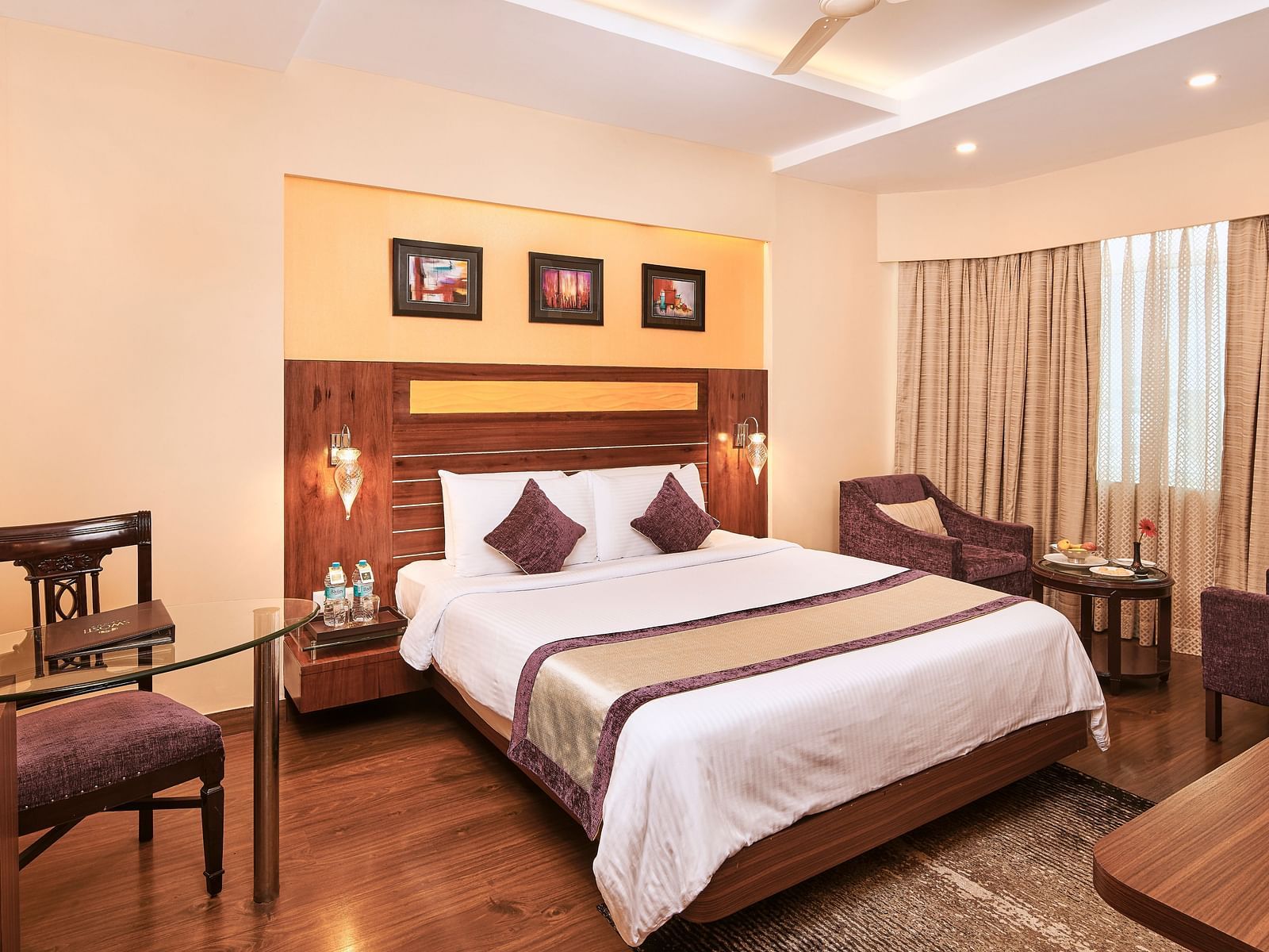 Side view of a room with bed and a seating area on the sides at Swosti Grand, Bhubaneswar