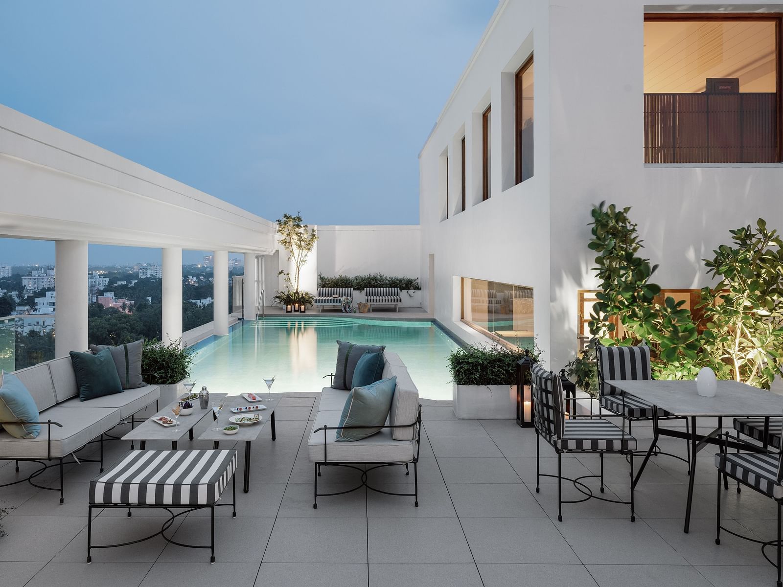 Image of a Swimming pool  with chairs and tables on the side at The Raintree St.. Mary s Road