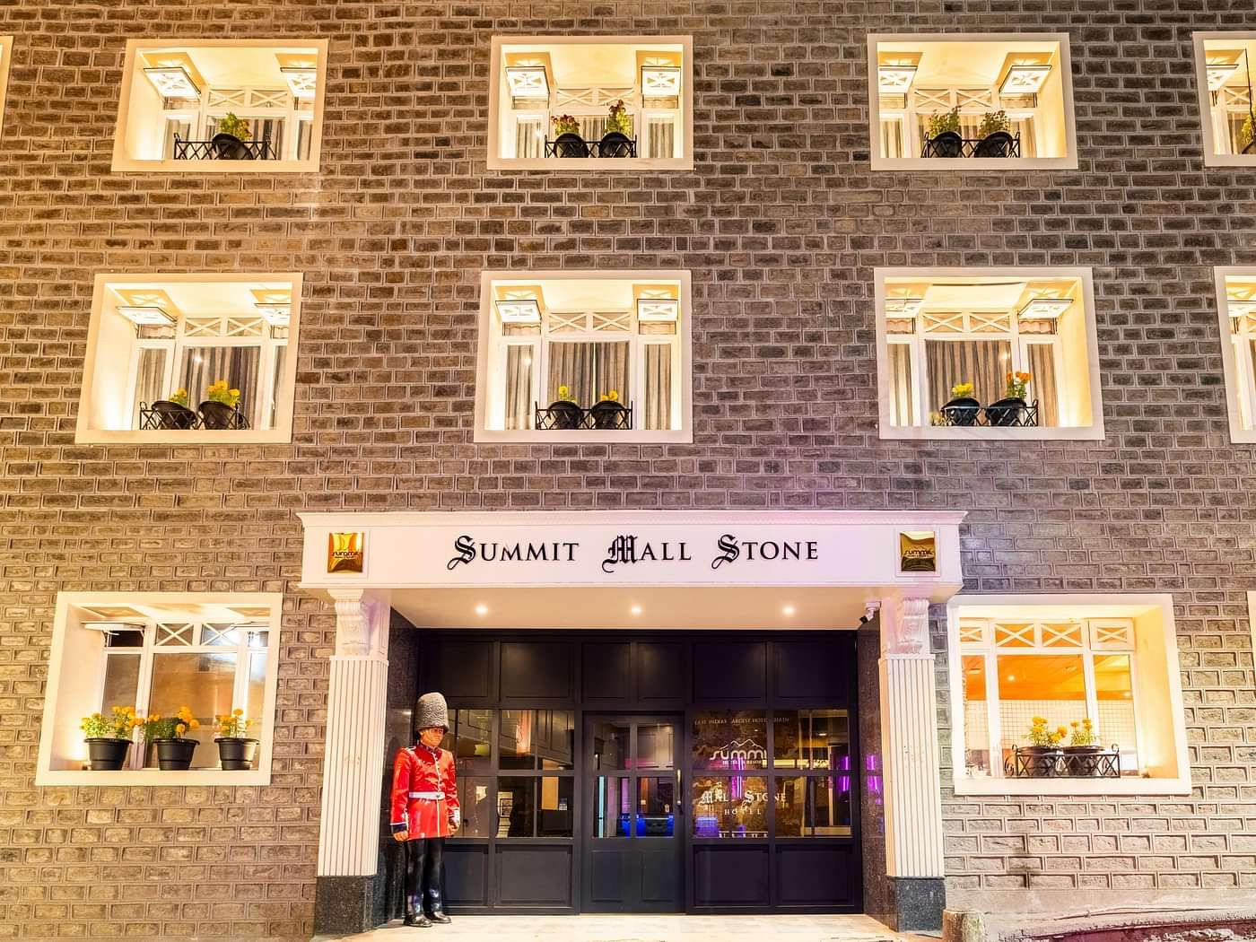 Front view of Summit Mall Stone Hotel, Darjeeling, showcasing room corridors with a distinctive block design