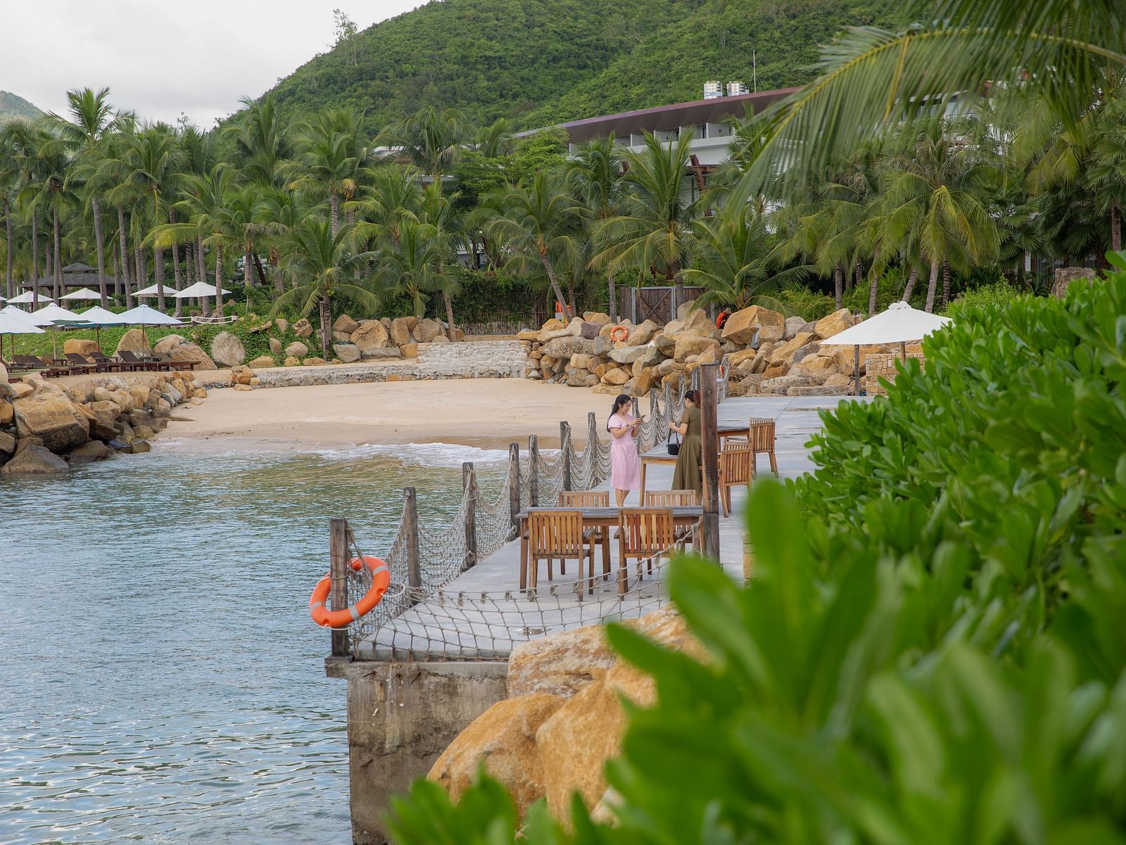 A seating arrangemnt by the Nah Trang bay covered by lush greeny - Alibu Resort Nha Trang