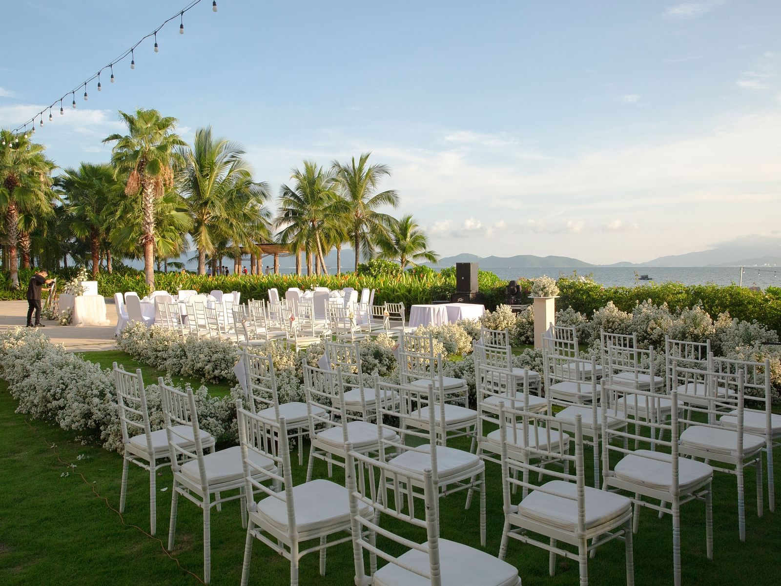 A classroom type seating arrangement with white chairs seen during a evening  - Alibu Resort Nha Trang