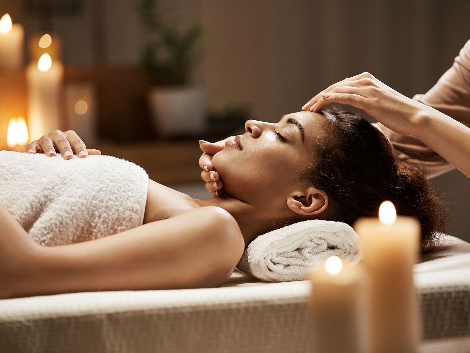 image of a woman recieving a relaxing and rejuvenating spa from a  masseuse 