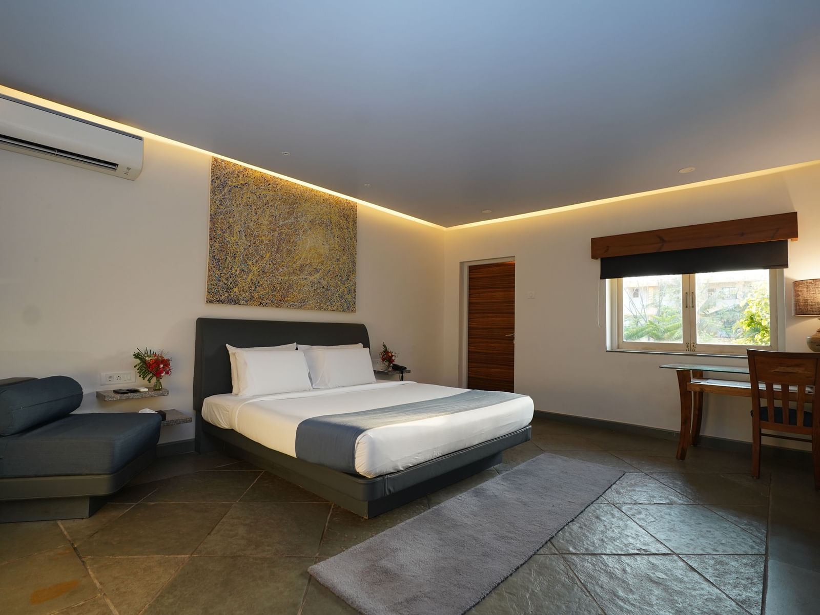 A bedroom with a double bed and wooden furnishings - Argo By Trance, Goa