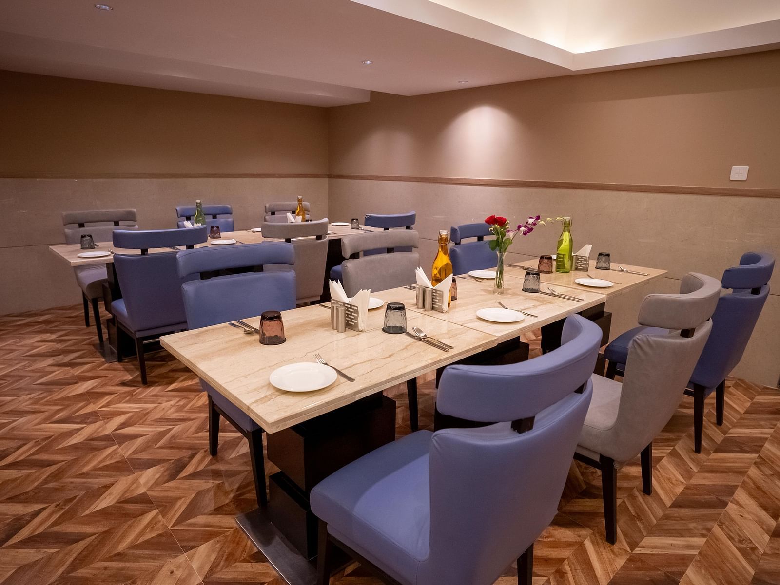 Nutmegg restaurant with neatly arranged tables and chairs at ASTER GRAND BY ZENQ SAKET.