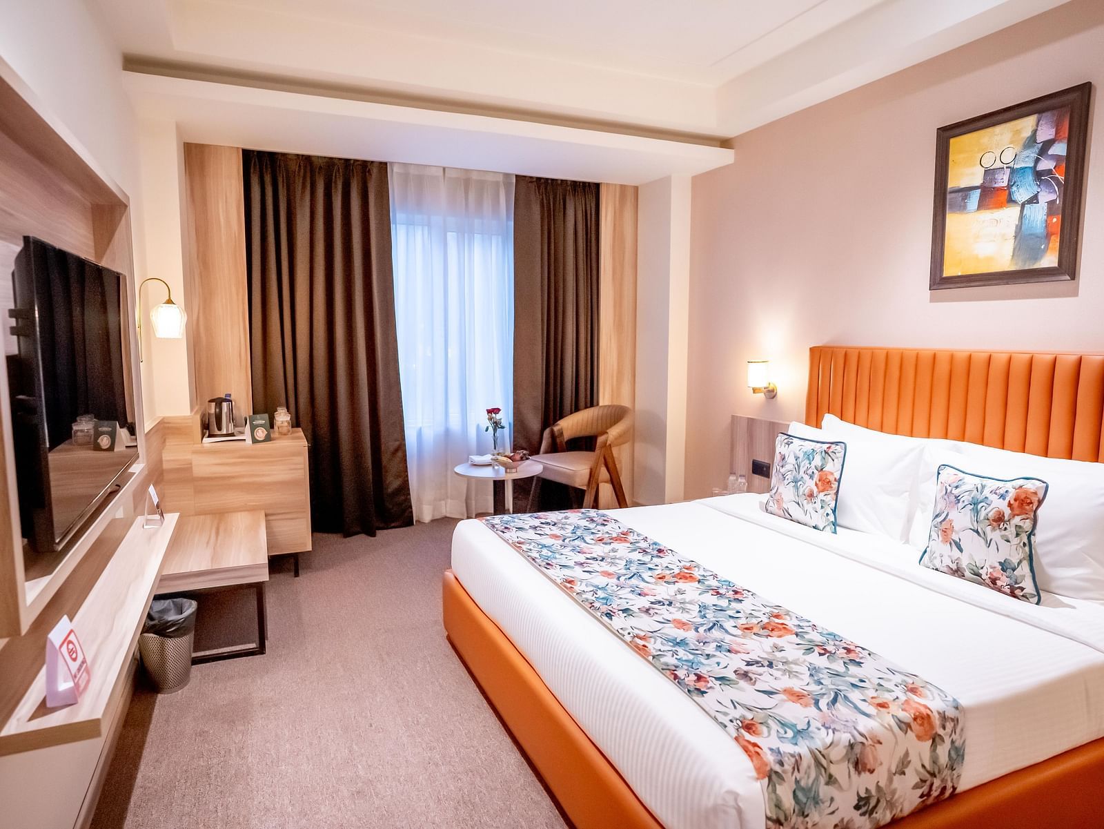 Superior Room at ASTER GRAND BY ZENQ SAKET with a bed, bed side table, TV, a chair and a window with curtain in the background.