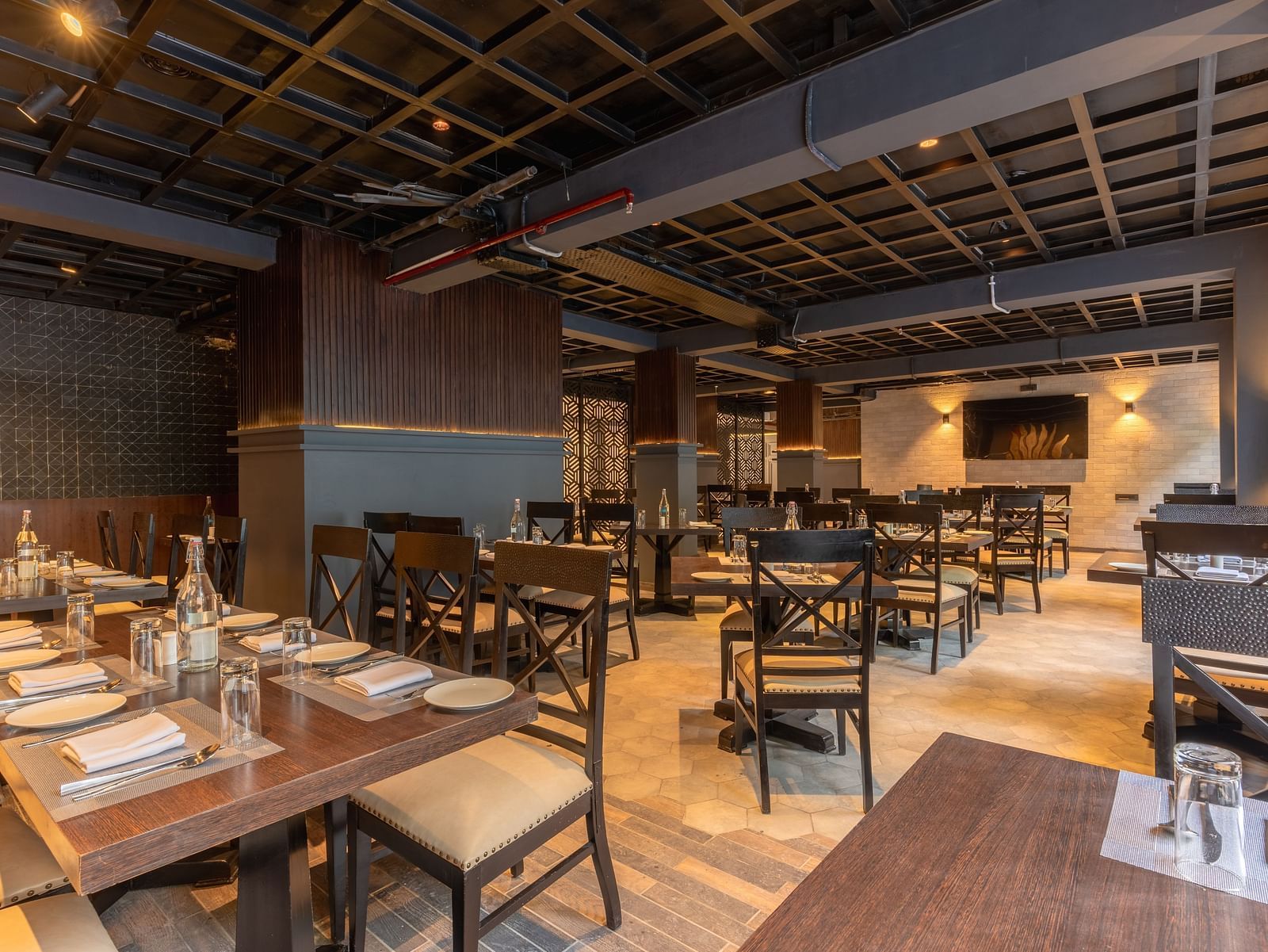 An image of a dinning area with wooden interior designs and table seating at Bedzzz Xclusiv Ikshana Luxe