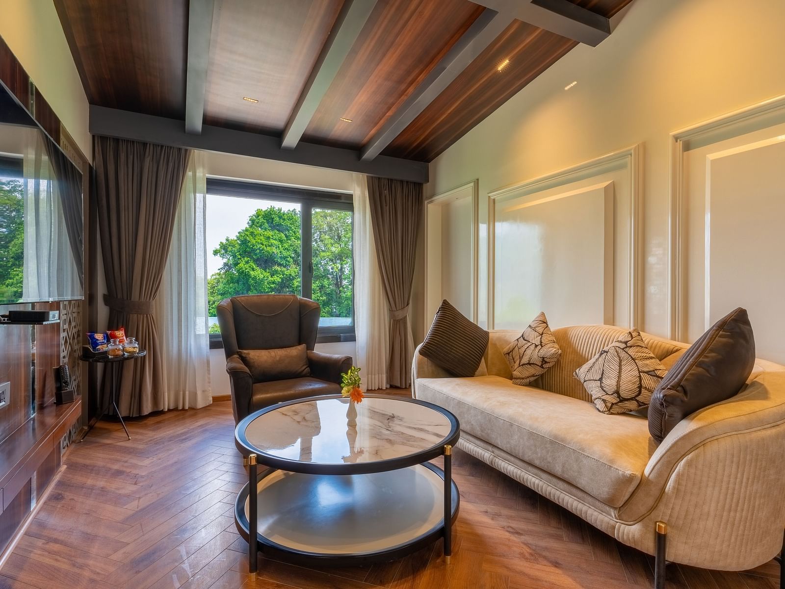 An image of a living area where sunlight has filled in on sofa, chair and a centre table -  roomat Bedzzz Xclusiv Ikshana Luxe