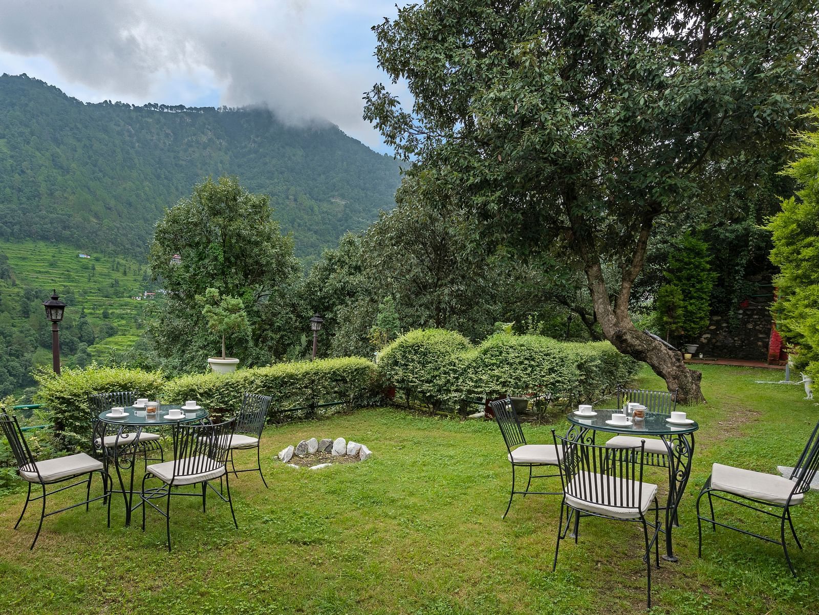 Outdoor lawn seating arranged in a circle with mountain views, at BluSalzz Collection - Suvaasa Resort, Ramgarh.