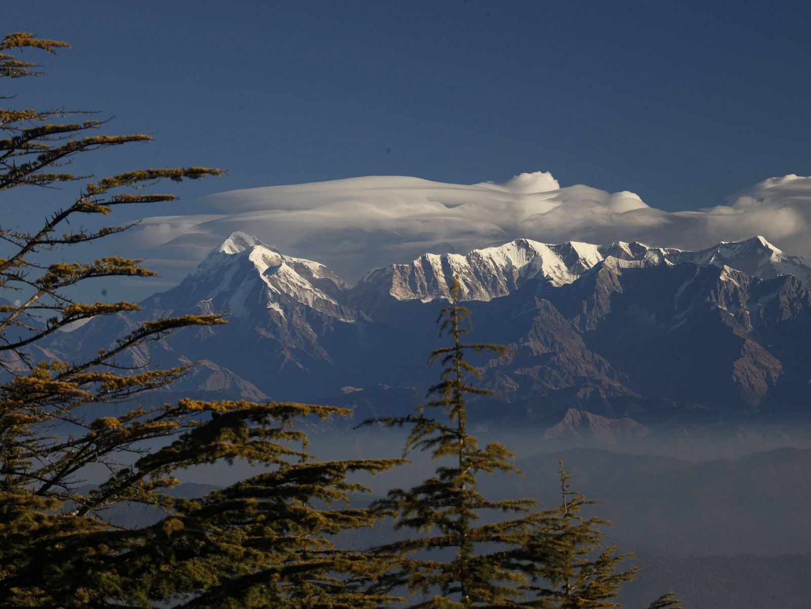 Snow-capped mountains under a clear blue sky seen from a distance - BluSalzz Escapade - Anant Rasa Resort