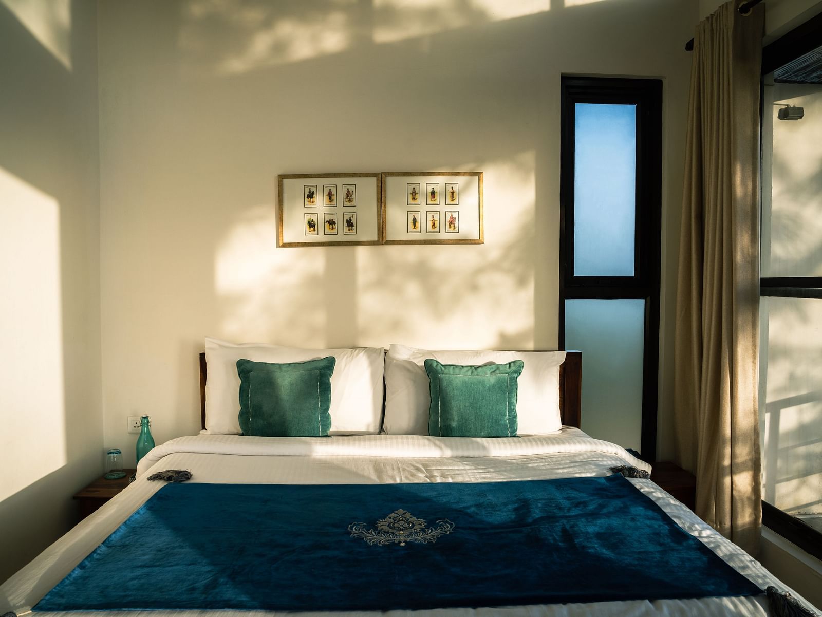A bedroom with sunlight streaming through the windows at BluSalzz Escapade Resort, Lansdowne.