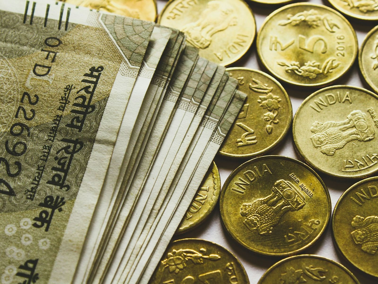 A close up shot of Indian currency notes and coins