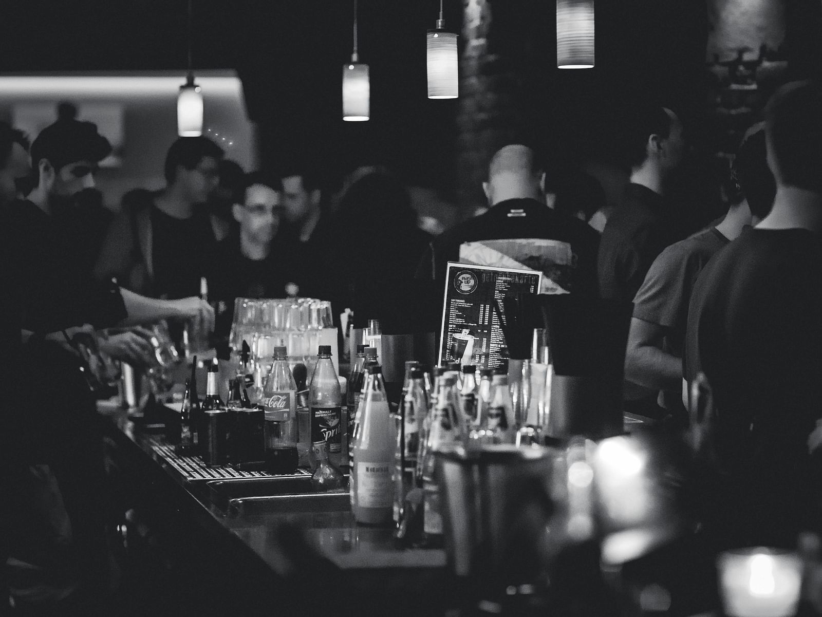 a bar counter with alcohol in bottles