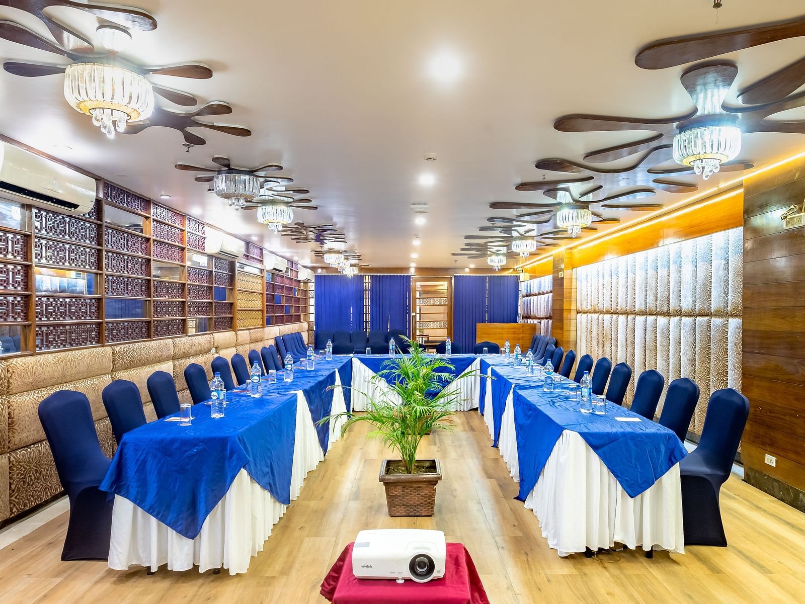 Meeting room at Diamond Palace Lords Plaza Nepalgunj with a U-shaped table facing a screen and decorated walls.
