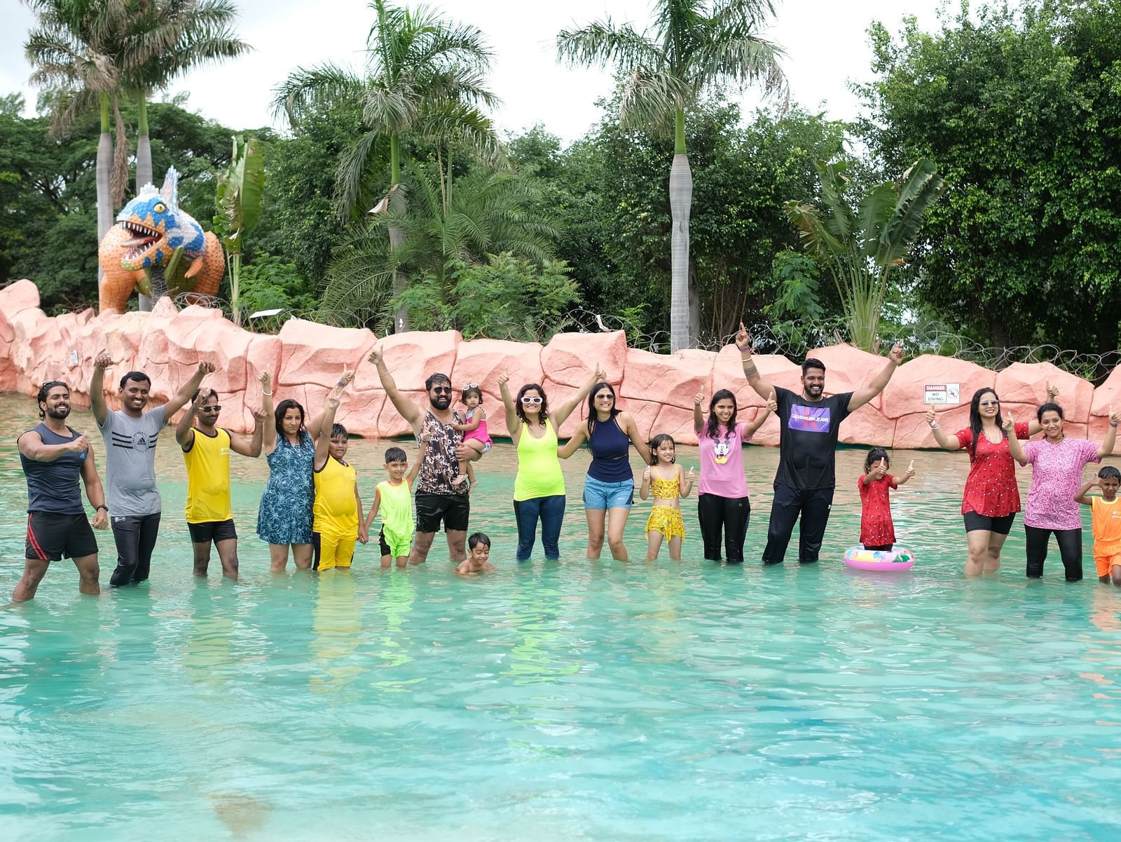 Group of friends posing joyfully in a shallow water pool at a theme park | Diamond Parks, Pune 