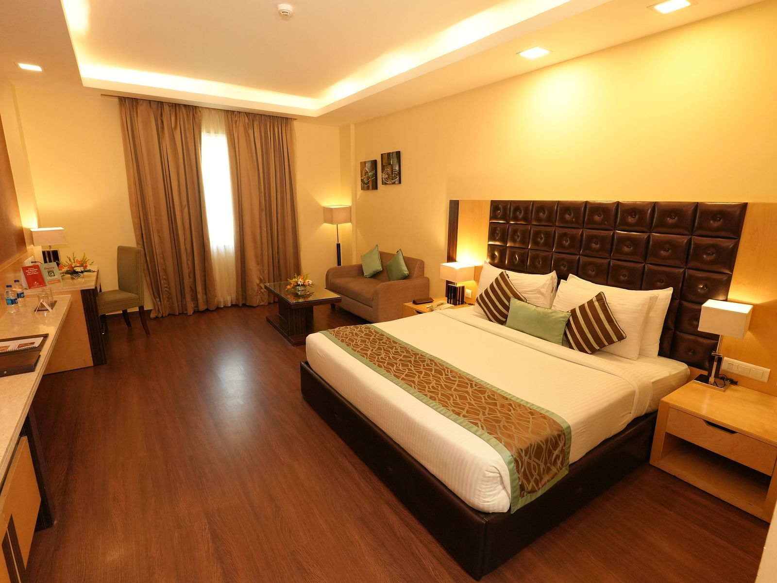 Guest room featuring a large bed and bedside tables - Grand Plaza Lords Inn Jammu