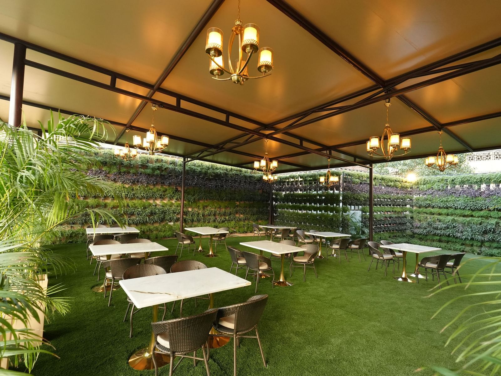Outdoor seating area with grass flooring and canopy roof - Grand Plaza Lords Inn Jammu